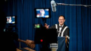 A picture of Santa Ono being filmed for graduation