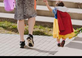 Parent and child go trick or treating