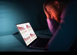 Investor puzzling over laptop