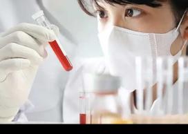Researcher looking at blood sample